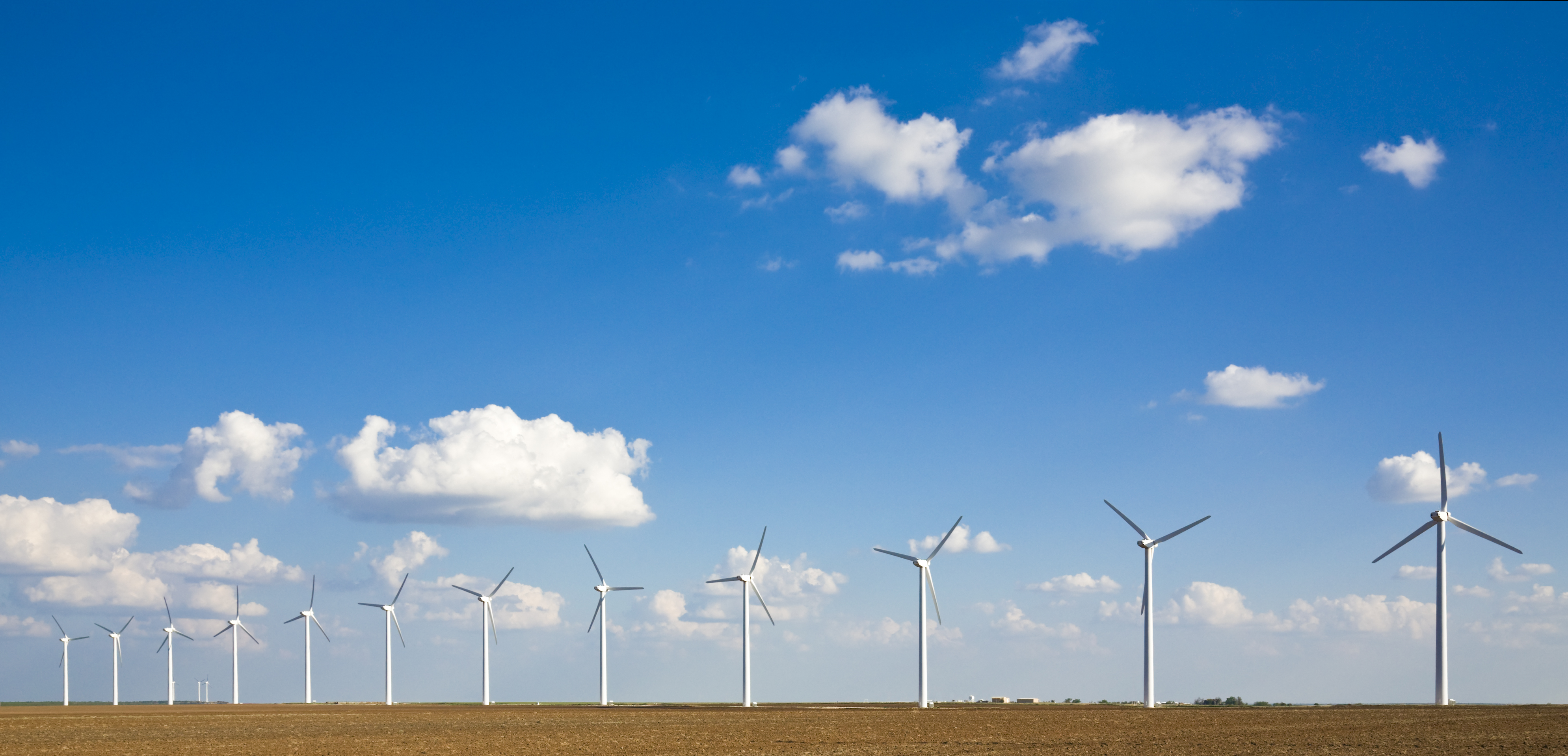 wind turbines in a row on the West Texas plains – Amis, Patel & Brewer, LLP